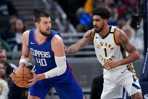 INDIANAPOLIS, INDIANA - DECEMBER 18: Ivica Zubac #40 of the Los Angeles Clippers handles the ball while being guarded by Obi Toppin #1 of the Indiana Pacers in the first quarter at Gainbridge Fieldhouse on December 18, 2023 in Indianapolis, Indiana. NOTE TO USER: User expressly acknowledges and agrees that, by downloading and or using this photograph, User is consenting to the terms and conditions of the Getty Images License Agreement. (Photo by Dylan Buell/Getty Images)