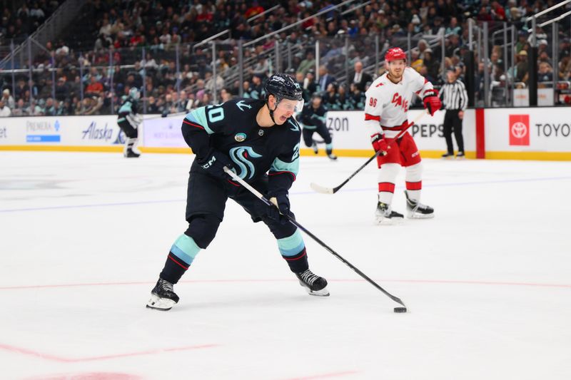 Oct 26, 2024; Seattle, Washington, USA; Seattle Kraken right wing Eeli Tolvanen (20) plays the puck during the third period against the Carolina Hurricanes at Climate Pledge Arena. Mandatory Credit: Steven Bisig-Imagn Images