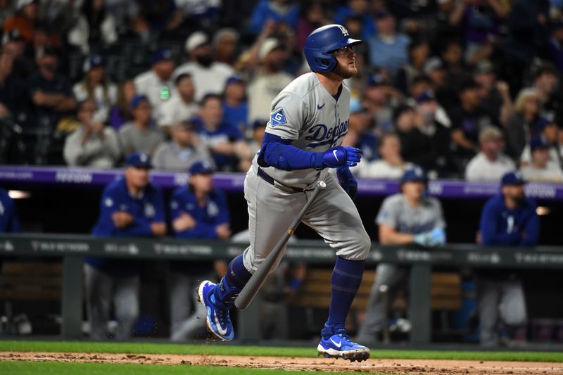 Jun 25, 2025; Denver, Colorado, USA; Los Angeles Dodgers third base Max Muncy (13) hits a grand slam during the seventh inning against the Colorado Rockies at Coors Field. Mandatory Credit: Christopher Hanewinckel-Imagn Images