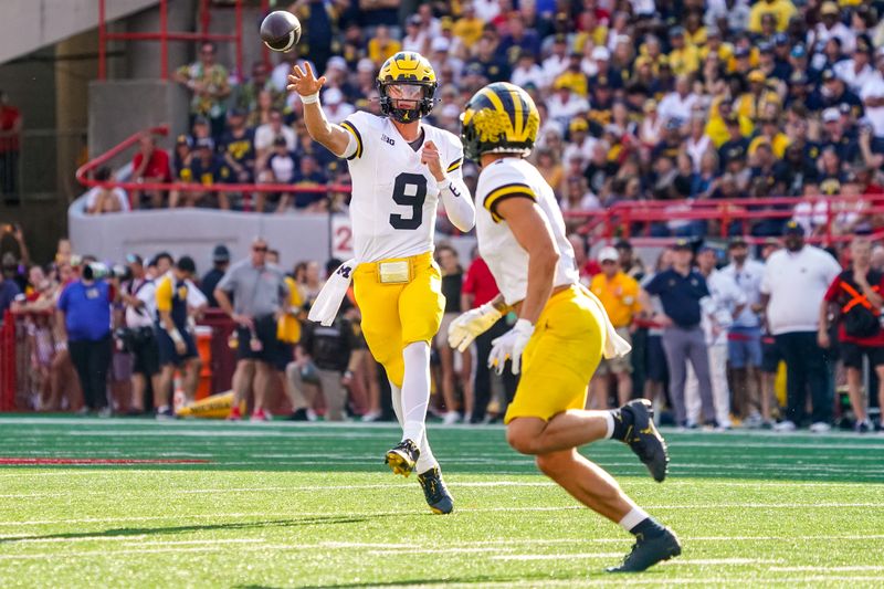 Sep 30, 2023; Lincoln, Nebraska, USA; Michigan Wolverines quarterback J.J. McCarthy (9) passes to wide receiver Roman Wilson (1) against the Nebraska Cornhuskers during the third quarter at Memorial Stadium. Mandatory Credit: Dylan Widger-USA TODAY Sports