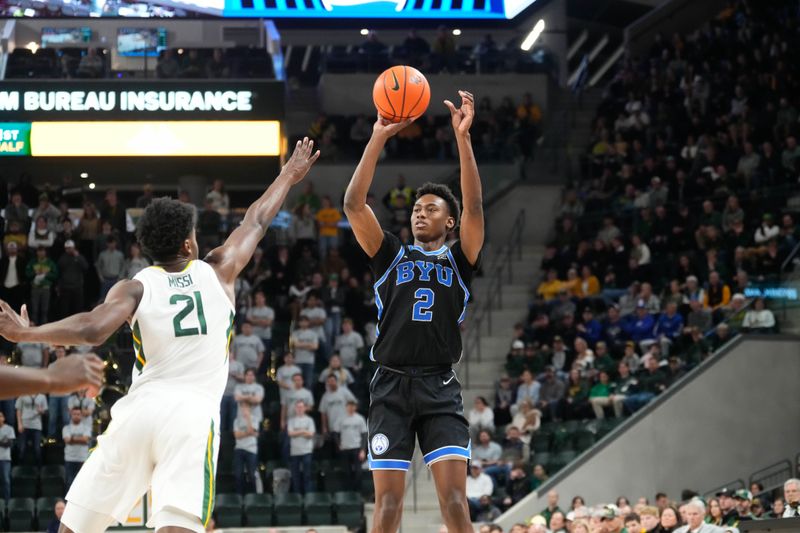 Jan 9, 2024; Waco, Texas, USA;  Brigham Young Cougars guard Jaxson Robinson (2) scores a three point basket against Baylor Bears center Yves Missi (21) during the first half at Paul and Alejandra Foster Pavilion. Mandatory Credit: Chris Jones-USA TODAY Sports