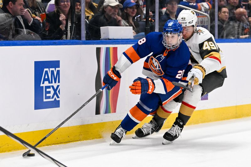 Jan 23, 2024; Elmont, New York, USA;  New York Islanders defenseman Alexander Romanov (28) skates with the puck from behind the net chased by Vegas Golden Knights center Ivan Barbashev (49) during the first period at UBS Arena. Mandatory Credit: Dennis Schneidler-USA TODAY Sports