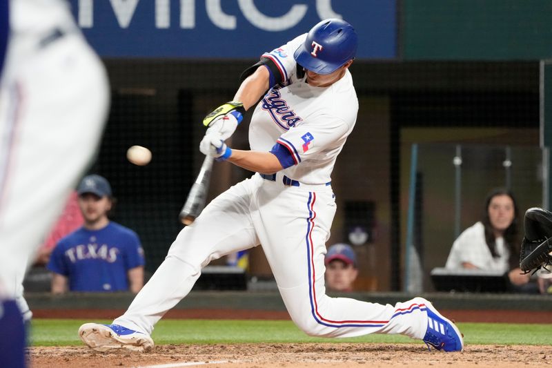 Apr 14, 2022; Arlington, Texas, USA; Texas Rangers shortstop Corey Seager (5) hits an RBI single against the Los Angeles Angels during the fifth inning of a baseball game at Globe Life Field. Mandatory Credit: Jim Cowsert-USA TODAY Sports