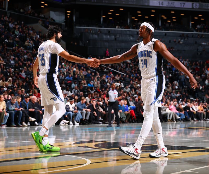 BROOKLYN, NY - NOVEMBER 29: Goga Bitadze #35 and Wendell Carter Jr. #34 of the Orlando Magic high five during the game against the Brooklyn Nets during a Emirates NBA Cup game on October 22, 2024 at Barclays Center in Brooklyn, New York. NOTE TO USER: User expressly acknowledges and agrees that, by downloading and or using this Photograph, user is consenting to the terms and conditions of the Getty Images License Agreement. Mandatory Copyright Notice: Copyright 2024 NBAE (Photo by David L. Nemec/NBAE via Getty Images)