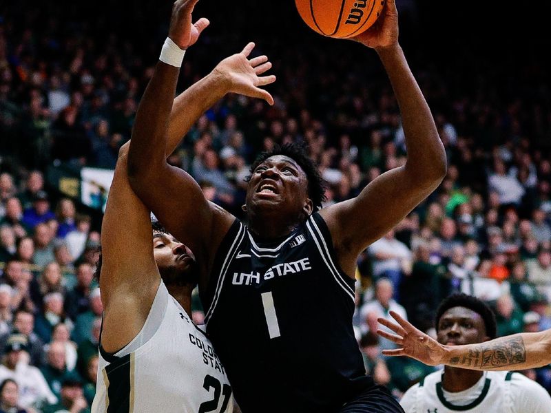 Feb 17, 2024; Fort Collins, Colorado, USA; Utah State Aggies forward Great Osobor (1) drives to the net against Colorado State Rams guard Rashaan Mbemba (21) in the first half at Moby Arena. Mandatory Credit: Isaiah J. Downing-USA TODAY Sports