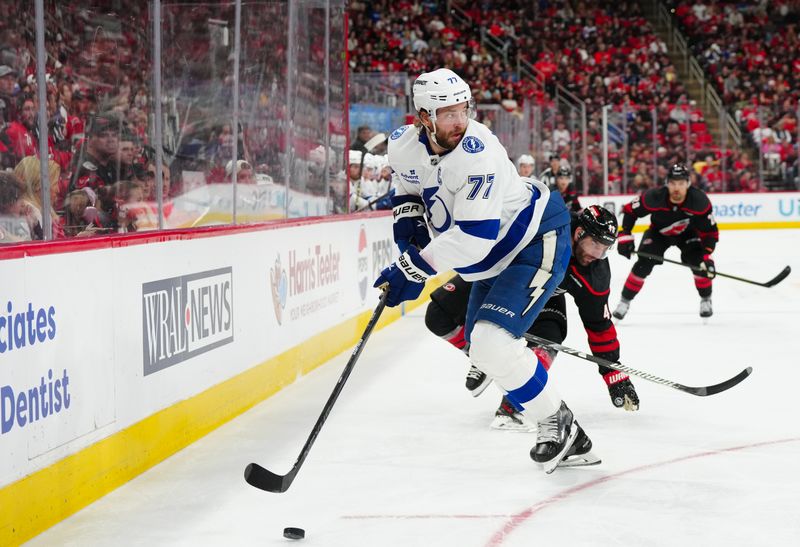 Oct 11, 2024; Raleigh, North Carolina, USA;  Tampa Bay Lightning defenseman Victor Hedman (77) skates with the puck against the Carolina Hurricanes during the first period at PNC Arena. Mandatory Credit: James Guillory-Imagn Images