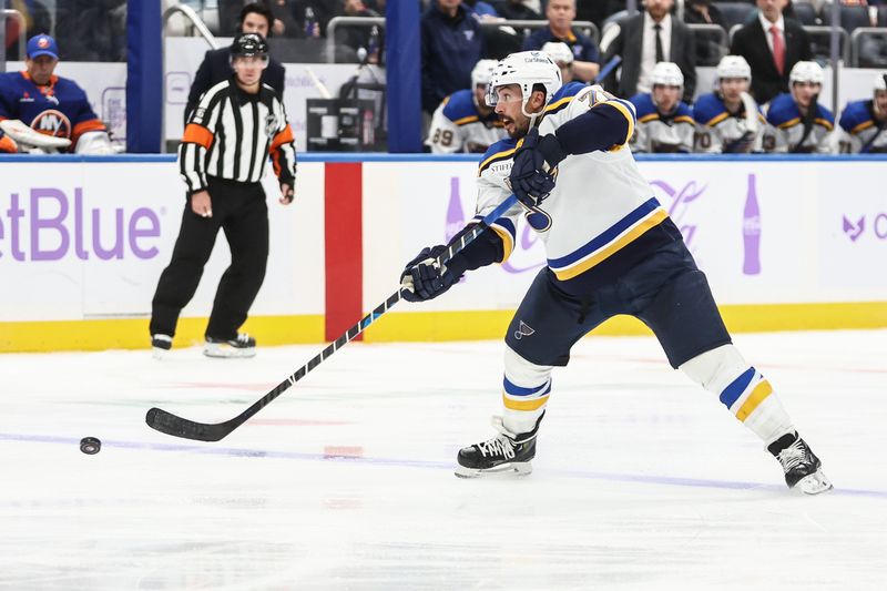 Nov 23, 2024; Elmont, New York, USA;  St. Louis Blues defenseman Justin Faulk (72) attempts a shot on goal in the third period against the New York Islanders at UBS Arena. Mandatory Credit: Wendell Cruz-Imagn Images