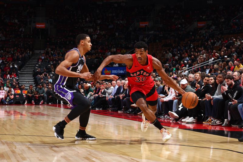 TORONTO, CANADA - MARCH 20: Ochai Agbaji #30 of the Toronto Raptors dribbles the ball during the game against the Sacramento Kings on March 20, 2024 at the Scotiabank Arena in Toronto, Ontario, Canada.  NOTE TO USER: User expressly acknowledges and agrees that, by downloading and or using this Photograph, user is consenting to the terms and conditions of the Getty Images License Agreement.  Mandatory Copyright Notice: Copyright 2024 NBAE (Photo by Vaughn Ridley/NBAE via Getty Images)