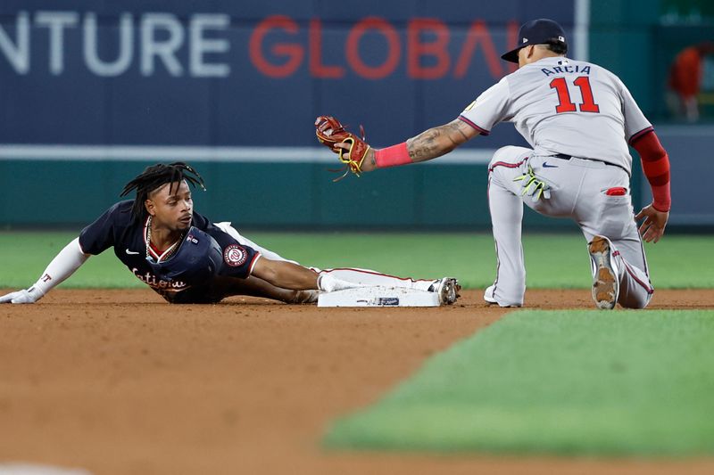 Sep 11, 2024; Washington, District of Columbia, USA; Washington Nationals third baseman Jose Tena (8) steals second base as Atlanta Braves shortstop Orlando Arcia (11) attempts the tag during the eighth inning at Nationals Park. Mandatory Credit: Geoff Burke-Imagn Images