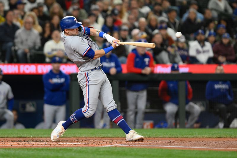 Sep 29, 2023; Seattle, Washington, USA; Texas Rangers third baseman Josh Jung (6) hits a single against the Seattle Mariners during the second inning at T-Mobile Park. Mandatory Credit: Steven Bisig-USA TODAY Sports