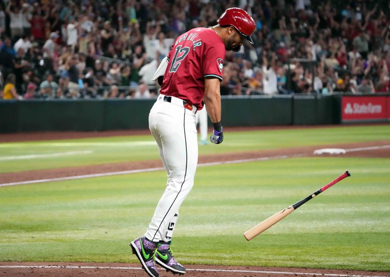 Jul 28, 2024; Phoenix, Arizona, USA; Arizona Diamondbacks outfielder Lourdes Gurriel Jr. (12) slams his bat after hitting a solo home run against the Pittsburgh Pirates during the tenth inning at Chase Field. Mandatory Credit: Joe Camporeale-USA TODAY Sports