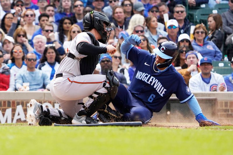 Jun 16, 2023; Chicago, Illinois, USA; Baltimore Orioles catcher Adley Rutschman (35) tags out Chicago Cubs catcher Miguel Amaya (6) at home plate during the sixth inning at Wrigley Field. Mandatory Credit: David Banks-USA TODAY Sports