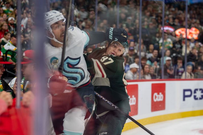 Oct 12, 2024; Saint Paul, Minnesota, USA; Minnesota Wild left wing Kirill Kaprizov (97) checks Seattle Kraken center Chandler Stephenson (9) in the overtime period at Xcel Energy Center. Mandatory Credit: Matt Blewett-Imagn Images