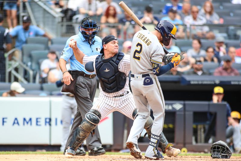 Sep 10, 2023; Bronx, New York, USA;  Milwaukee Brewers second baseman Brice Turang (2) drops back as New York Yankees catcher Ben Rortvedt (38) attempts to throw a runner out at second base after a wild pitch at Yankee Stadium. Mandatory Credit: Wendell Cruz-USA TODAY Sports