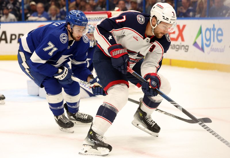 Apr 9, 2024; Tampa, Florida, USA; Columbus Blue Jackets center Sean Kuraly (7) skates with the puck a as Tampa Bay Lightning center Anthony Cirelli (71) defends during the second period at Amalie Arena. Mandatory Credit: Kim Klement Neitzel-USA TODAY Sports