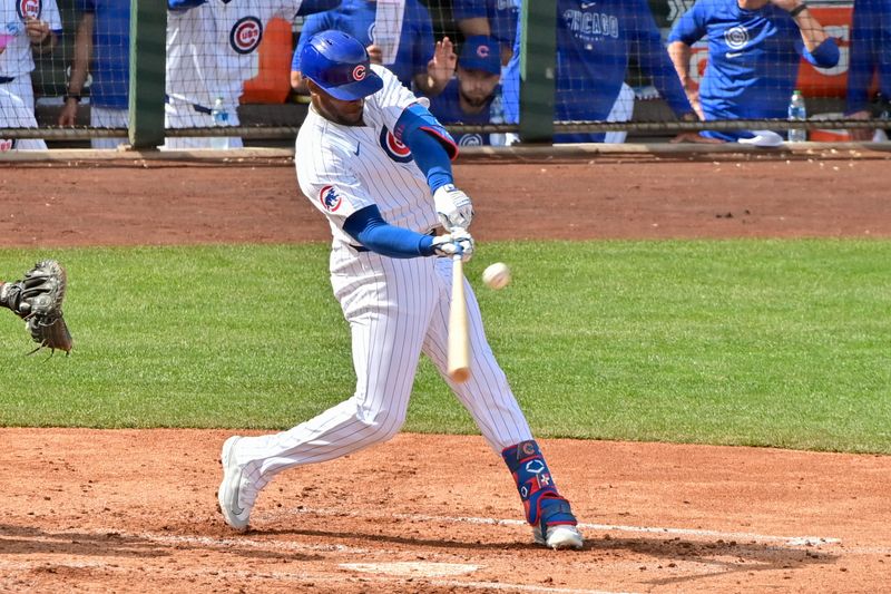 Feb 27, 2024; Mesa, Arizona, USA;  Chicago Cubs center fielder Alexander Canario (4) flies out in the third inning against the Cincinnati Reds during a spring training game at Sloan Park. Mandatory Credit: Matt Kartozian-USA TODAY Sports