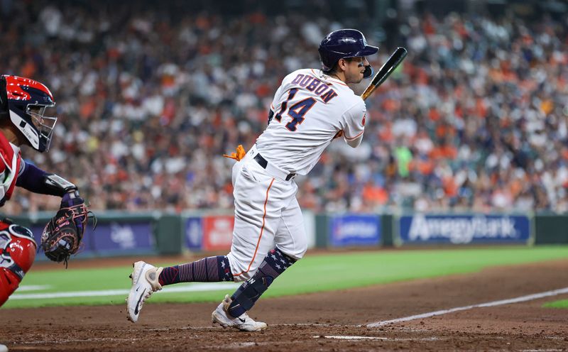 Jul 4, 2023; Houston, Texas, USA; Houston Astros second baseman Mauricio Dubon (14) hits an RBI triple during the fifth inning against the Colorado Rockies at Minute Maid Park. Mandatory Credit: Troy Taormina-USA TODAY Sports