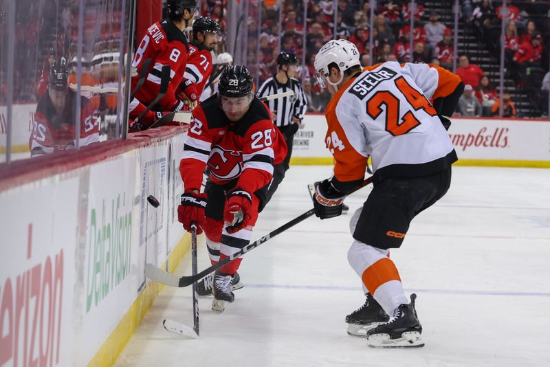 Jan 18, 2025; Newark, New Jersey, USA; New Jersey Devils right wing Timo Meier (28) and Philadelphia Flyers defenseman Nick Seeler (24) battle for the puck during the second period at Prudential Center. Mandatory Credit: Ed Mulholland-Imagn Images