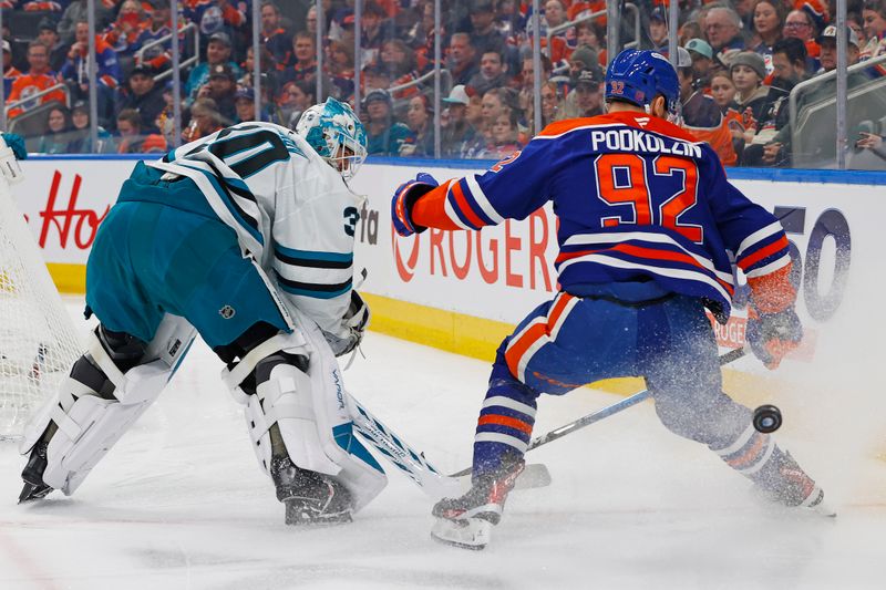 Jan 29, 2026; Edmonton, Alberta, CAN; San Jose Sharks goaltender Yaroslav Askarov (30) clears the puck in front of Edmonton Oilers 92 during the first period at Rogers Place. Mandatory Credit: Perry Nelson-Imagn Images