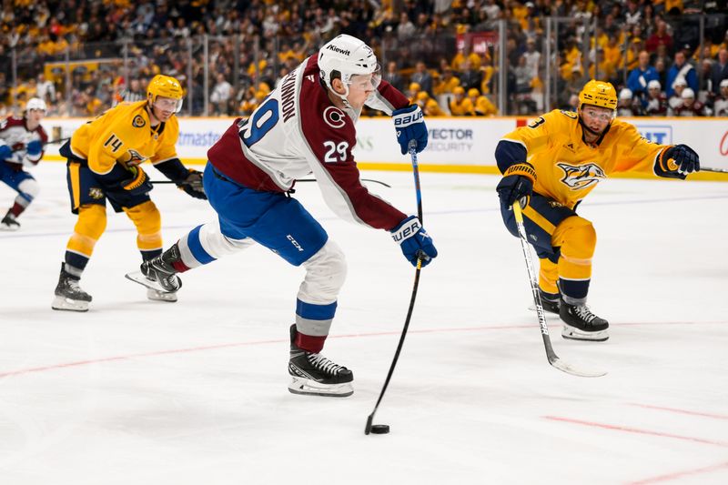 Nov 2, 2024; Nashville, Tennessee, USA;  Colorado Avalanche center Nathan MacKinnon (29) takes a shot on goal against the Nashville Predators during the second period at Bridgestone Arena. Mandatory Credit: Steve Roberts-Imagn Images