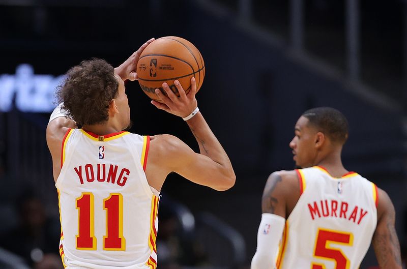 ATLANTA, GEORGIA - FEBRUARY 09:  Trae Young #11 of the Atlanta Hawks shoots a three-point basket against the Phoenix Suns during the fourth quarter at State Farm Arena on February 09, 2023 in Atlanta, Georgia.  NOTE TO USER: User expressly acknowledges and agrees that, by downloading and or using this photograph, User is consenting to the terms and conditions of the Getty Images License Agreement. (Photo by Kevin C. Cox/Getty Images)