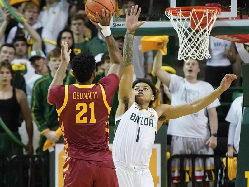 Mar 4, 2023; Waco, Texas, USA; Iowa State Cyclones center Osun Osunniyi (21) shoots the ball over Baylor Bears guard Keyonte George (1) during the second half at Ferrell Center. Mandatory Credit: Raymond Carlin III-USA TODAY Sports