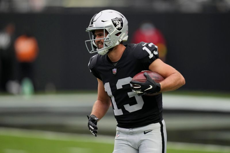 Las Vegas Raiders wide receiver Hunter Renfrow (13) warms up before an NFL football game against the Arizona Cardinals, Sunday, Sept. 18, 2022, in Las Vegas. (AP Photo/John Locher)