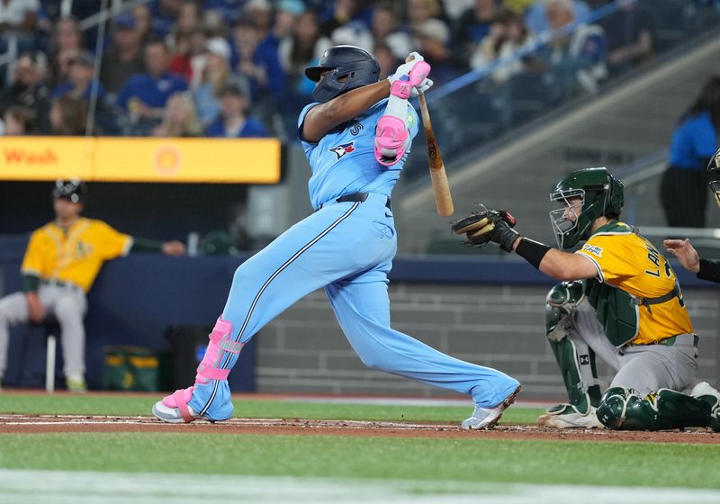 May 31, 2025; Toronto, Ontario, CAN; Toronto Blue Jays first baseman Vladimir Guerrero Jr. (27) hits a single against the Athletics during the first inning at Rogers Centre. Mandatory Credit: Nick Turchiaro-Imagn Images
