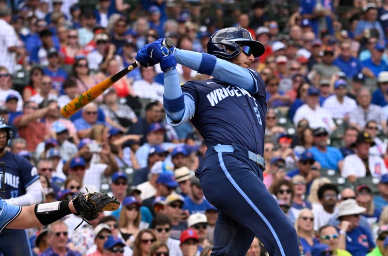 Aug 16, 2024; Chicago, Illinois, USA;  Chicago Cubs outfielder Cody Bellinger (24) hits a two run home run against the Toronto Blue Jays during the first inning at Wrigley Field. Mandatory Credit: Matt Marton-USA TODAY Sports