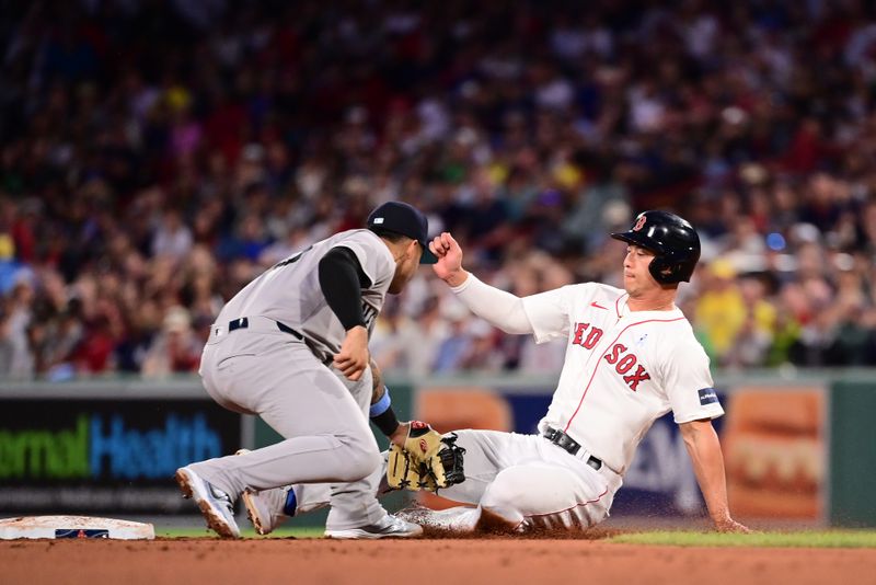 Jun 16, 2024; Boston, Massachusetts, USA; Boston Red Sox right fielder Rob Refsnyder (30) is tagged out trying to steal second base from New York Yankees second baseman Gleyber Torres (25) during the fifth inning at Fenway Park. Mandatory Credit: Eric Canha-USA TODAY Sports