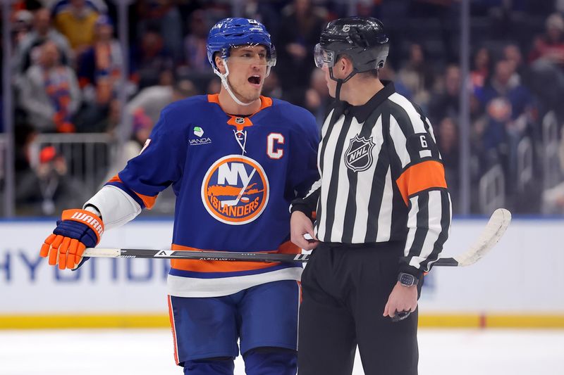 Jan 24, 2026; Elmont, New York, USA; New York Islanders left wing Anders Lee (27) talks to referee Francis Charron (6) after a disallowed goal during the first period against the Buffalo Sabres at UBS Arena. Mandatory Credit: Brad Penner-Imagn Images