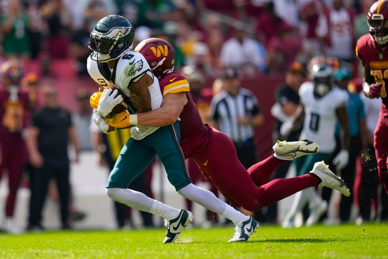 Philadelphia Eagles wide receiver DeVonta Smith (6) is tackled by Washington Commanders linebacker David Mayo (51) during the first half of an NFL football game, Sunday, Oct. 29, 2023, in Landover, Md. (AP Photo/Alex Brandon)