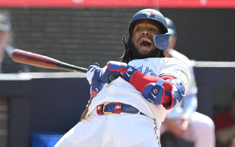 Jun 16, 2024; Toronto, Ontario, CAN;  Toronto Blue Jays first baseman Vladimir Guerrero Jr. (27) reacts after ducking away from an inside pitch from Cleveland Guardians relief pitcher Pedro Avila (not shown) in the eighth inning at Rogers Centre. Mandatory Credit: Dan Hamilton-USA TODAY Sports