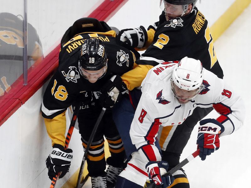 Mar 7, 2024; Pittsburgh, Pennsylvania, USA; Washington Capitals left wing Alex Ovechkin (8) moves the puck against Pittsburgh Penguins right wing Jesse Puljujarvi (18) and defenseman Chad Ruhwedel (2) during the third period at PPG Paints Arena. The Capitals shutout the Penguins 6-0. Mandatory Credit: Charles LeClaire-USA TODAY Sports