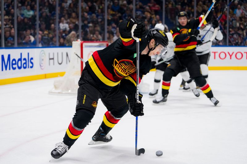 Feb 29, 2024; Vancouver, British Columbia, CAN; Vancouver Canucks forward Ilya Mikheyev (65) handles the puck against the Los Angeles Kings in the first period at Rogers Arena. Mandatory Credit: Bob Frid-USA TODAY Sports