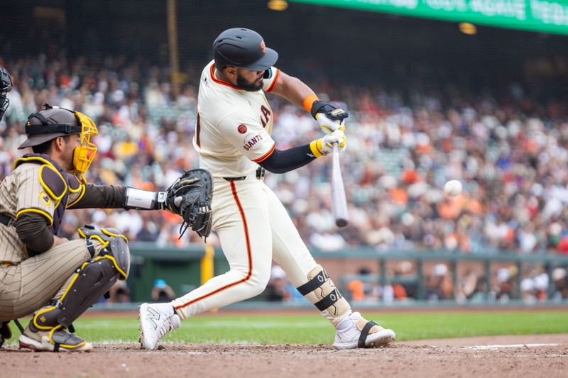 Sep 15, 2024; San Francisco, California, USA; San Francisco Giants outfielder Heliot Ramos (21) hits a solo home run during the ninth inning against the San Diego Padres at Oracle Park. Mandatory Credit: Bob Kupbens-Imagn Images