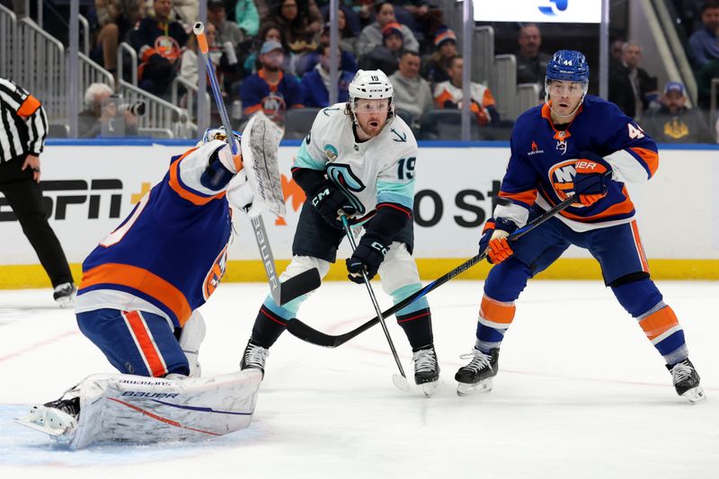 Dec 5, 2024; Elmont, New York, USA; Seattle Kraken left wing Jared McCann (19) and New York Islanders center Jean-Gabriel Pageau (44) watch as Islanders goaltender Ilya Sorokin (30) makes a save during the first period at UBS Arena. Mandatory Credit: Brad Penner-Imagn Images