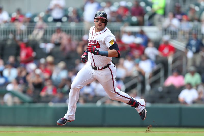 Aug 4, 2024; Cumberland, Georgia, USA; Atlanta Braves third baseman Austin Riley (27) runs to second base in the third inning during the game against Miami Marlins at Truist Park. Mandatory Credit: Mady Mertens-USA TODAY Sports