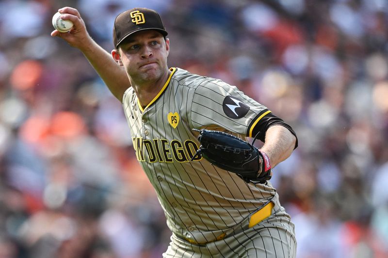 Jul 27, 2024; Baltimore, Maryland, USA; San Diego Padres pitcher Michael King (34) throws to first base after fielding Baltimore Orioles shortstop Gunnar Henderson (2) first inning ground ball  at Oriole Park at Camden Yards. Mandatory Credit: Tommy Gilligan-USA TODAY Sports