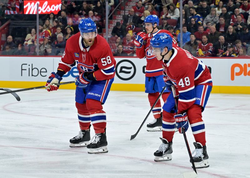 Oct 26, 2024; Montreal, Quebec, CAN; Montreal Canadiens defenseman David Savard (58) talks to defenseman Lane Hutson (48) before a faceoff against the St.Louis Blues during the second period at the Bell Centre. Mandatory Credit: Eric Bolte-Imagn Images