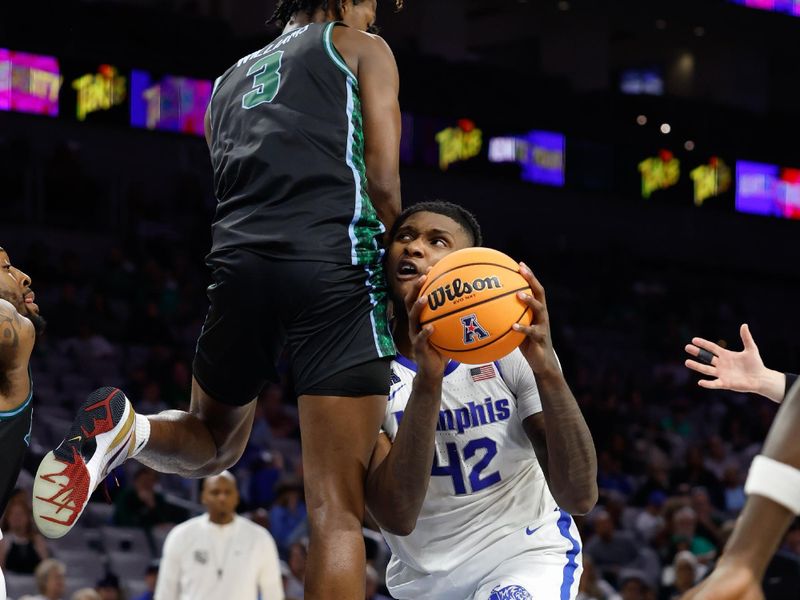Mar 15, 2025; Fort Worth, TX, USA; Memphis Tigers forward Dain Dainja (42) drives to the basket and is fouled by Tulane Green Wave guard Kam Williams (3) during the second half at Dickies Arena. Mandatory Credit: Chris Jones-Imagn Images