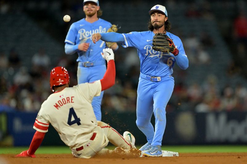 Sep 24, 2025; Anaheim, California, USA;  Los Angeles Angels second baseman Christian Moore (4) is out as Kansas City Royals second baseman Jonathan India (6) throws to first for a double play during the sixth inning at Angel Stadium. Mandatory Credit: Jayne Kamin-Oncea-Imagn Images