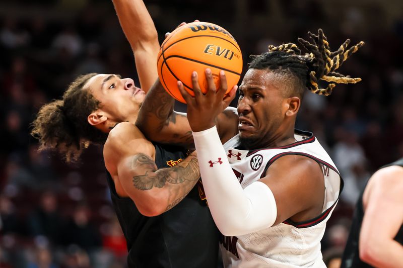 Dec 19, 2023; Columbia, South Carolina, USA; South Carolina Gamecocks forward B.J. Mack (2) attempts to drive past Winthrop Eagles forward Kelton Talford (4) in the second half at Colonial Life Arena. Mandatory Credit: Jeff Blake-USA TODAY Sports