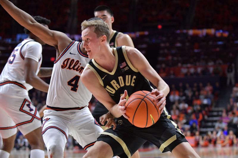 Mar 5, 2024; Champaign, Illinois, USA; Purdue Boilermakers guard Fletcher Loyer (2) drives the ball around Illinois Fighting Illini guard Justin Harmon (4) during the second half at State Farm Center. Mandatory Credit: Ron Johnson-USA TODAY Sports