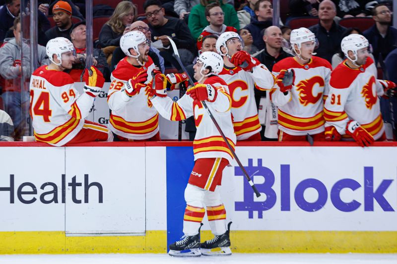 Jan 13, 2025; Chicago, Illinois, USA; Calgary Flames left wing Jakob Pelletier (22) celebrates with teammates after scoring against the Chicago Blackhawks during the first period at United Center. Mandatory Credit: Kamil Krzaczynski-Imagn Images