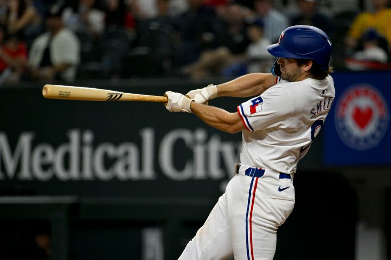 Apr 27, 2024; Arlington, Texas, USA; Texas Rangers third baseman Josh Smith (8) hits a double and drives in a run against the Cincinnati Reds during the ninth inning at Globe Life Field. Mandatory Credit: Jerome Miron-USA TODAY Sports