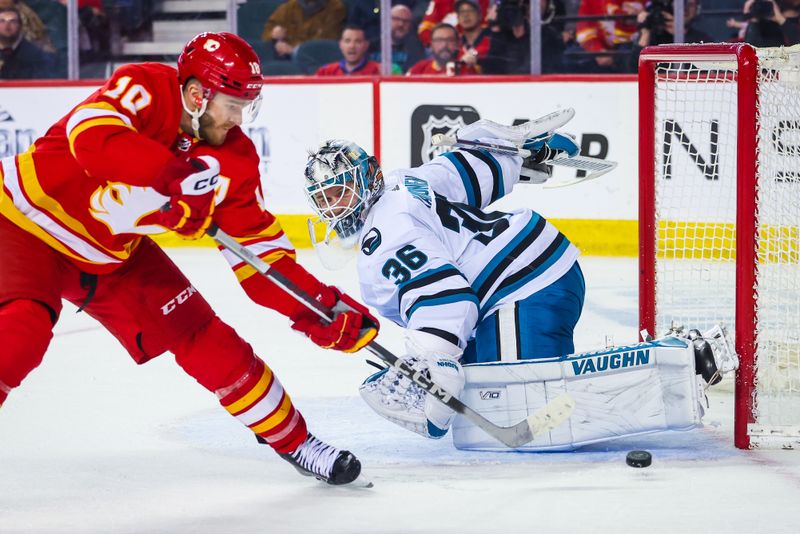 Apr 12, 2023; Calgary, Alberta, CAN; San Jose Sharks goaltender Kaapo Kahkonen (36) makes a save against Calgary Flames center Jonathan Huberdeau (10) during the third period at Scotiabank Saddledome. Mandatory Credit: Sergei Belski-USA TODAY Sports