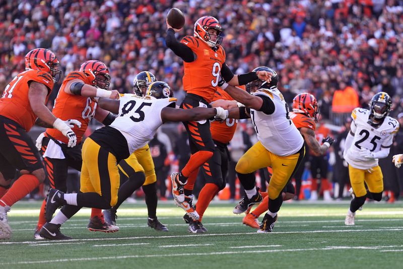 Cincinnati Bengals quarterback Joe Burrow leaps as he throws a touchdown pass to Cincinnati Bengals wide receiver Ja'Marr Chase (not pictured) during the first half of an NFL football game against the Pittsburgh Steelers, Sunday, Dec. 1, 2024, in Cincinnati. (AP Photo/Kareem Elgazzar)