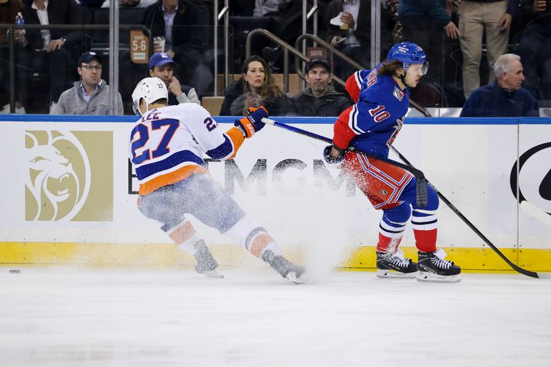 Nov 8, 2022; New York, New York, USA; New York Islanders left wing Anders Lee (27) and New York Rangers left wing Artemi Panarin (10) fight for the puck during the first period of a game at Madison Square Garden. Mandatory Credit: Jessica Alcheh-USA TODAY Sports