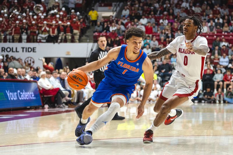 Mar 5, 2025; Tuscaloosa, Alabama, USA; Florida Gators guard Walter Clayton Jr. (1) drives the ball against Alabama Crimson Tide guard Labaron Philon (0) during the first half at Coleman Coliseum. Mandatory Credit: Will McLelland-Imagn Images